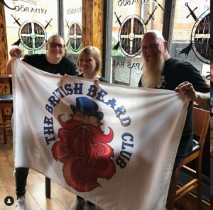 Stockport Beards Meet - May 2019 - Boff and others hold up the TBBC flag